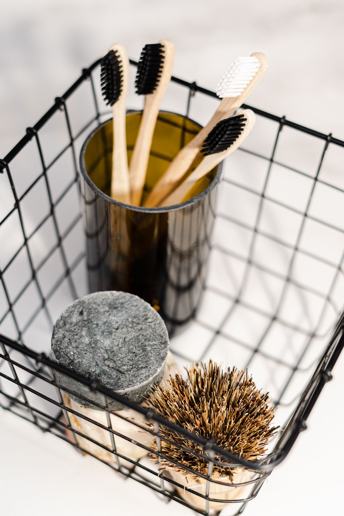 Toothbrushes and toiletries in a wire bathroom basket