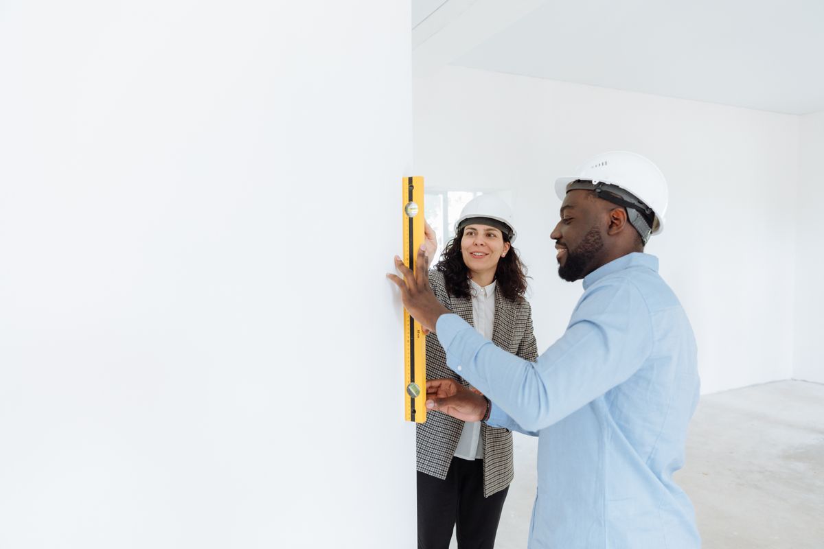 A spirit level held against an indoor wall