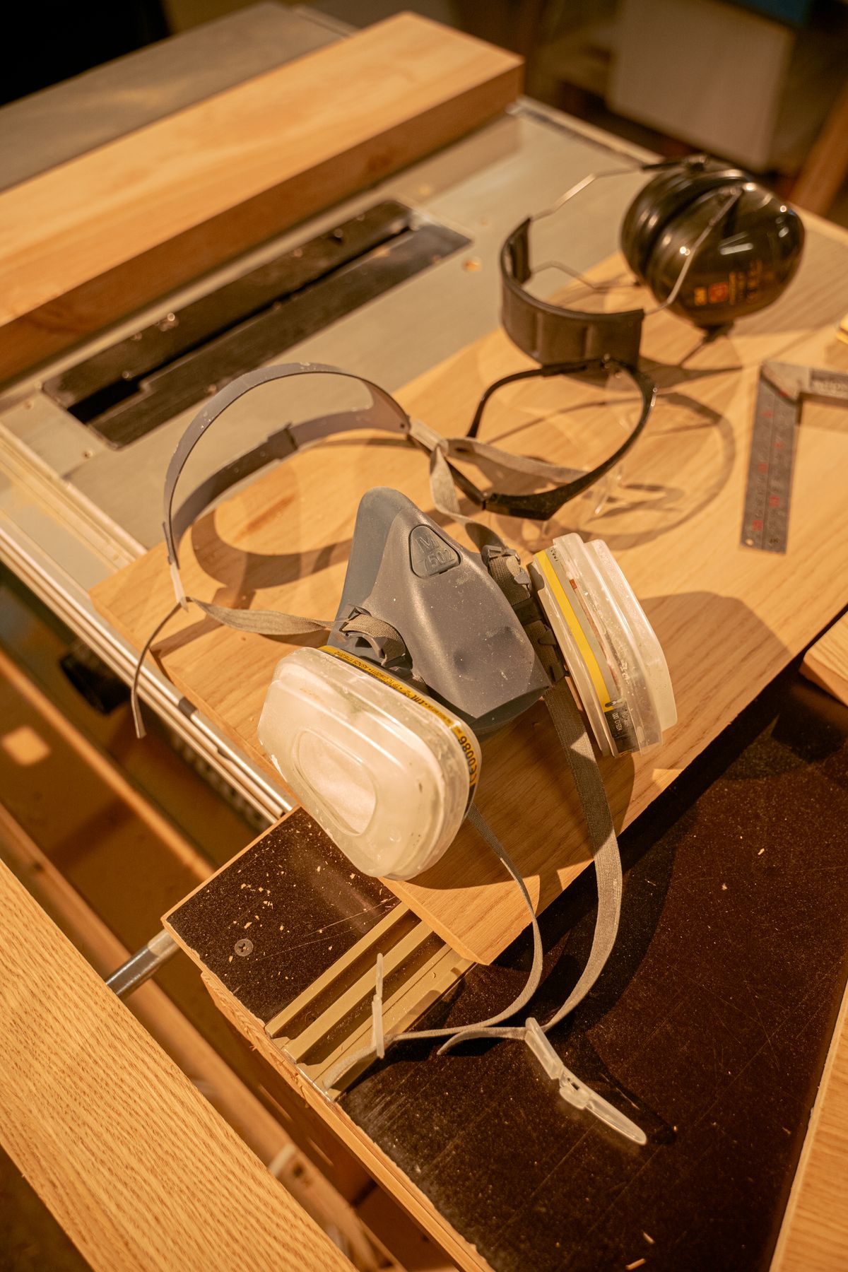 A respirator and hearing protection on a workshop table
