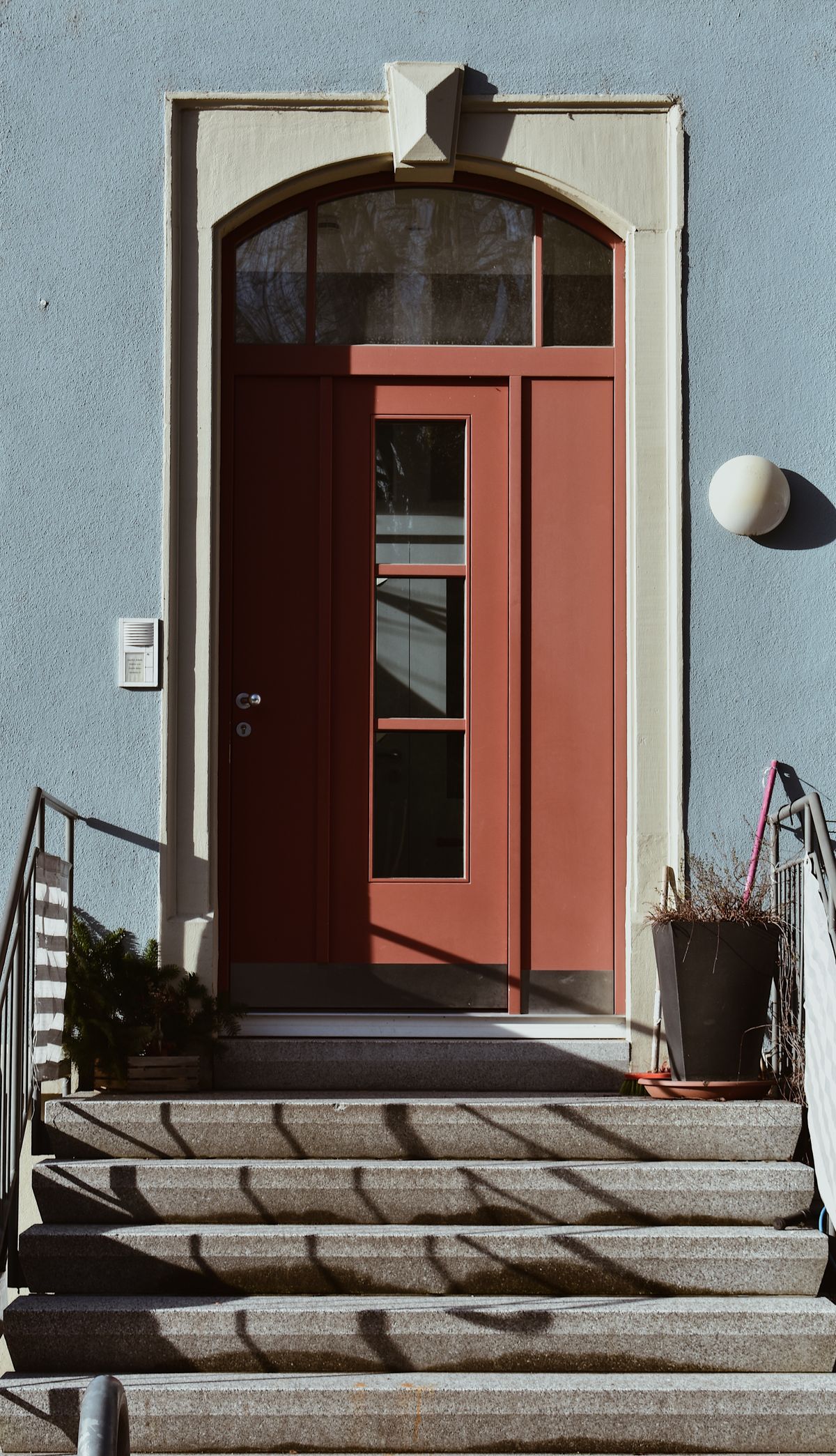House front steps leading to a red door