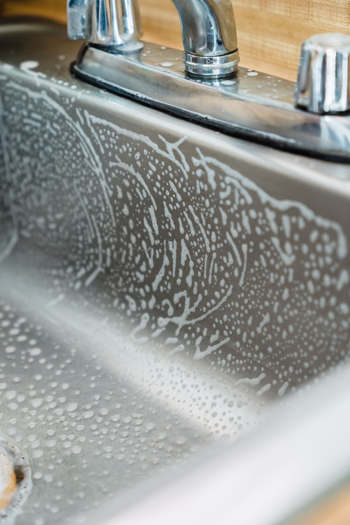 A stainless-steel kitchen sink during a routine clean
