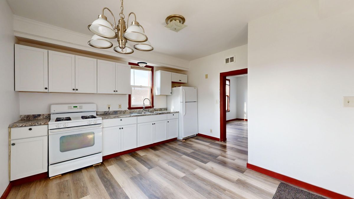 Laminate flooring across a bright kitchen