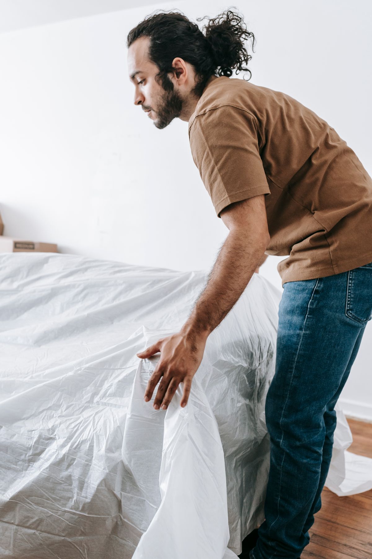 Furniture being covered with a protective sheet