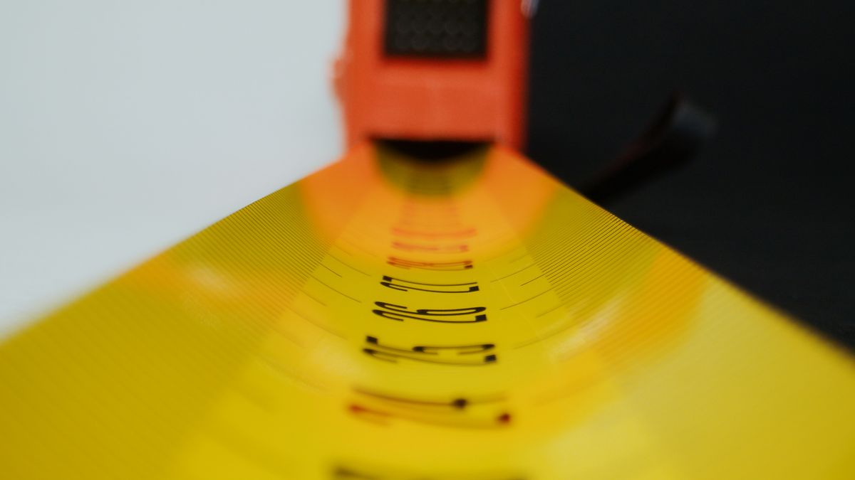 Close-up of a yellow tape measure and its numbered scale