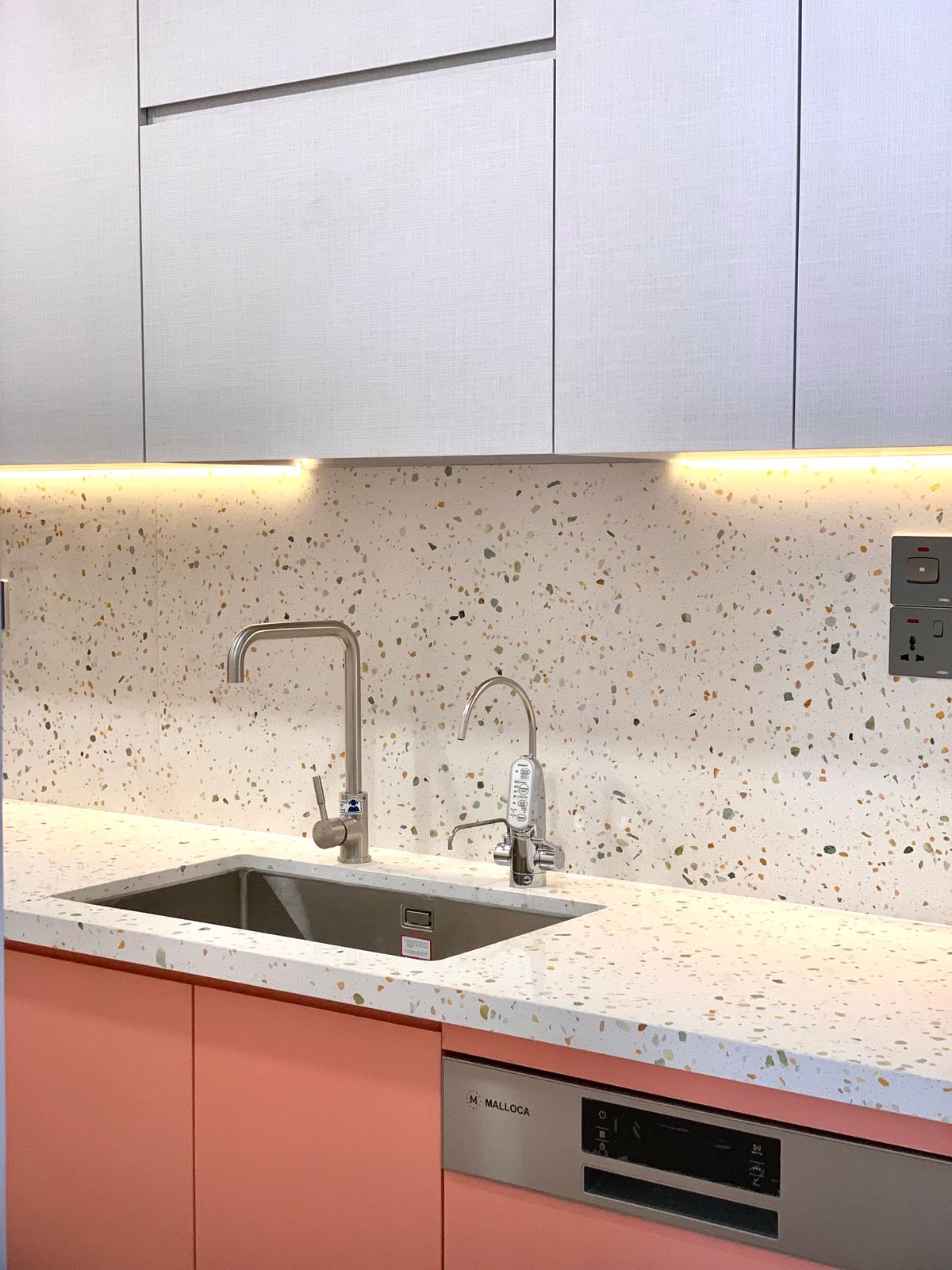 Kitchen sink edges and worktop meeting a splashback